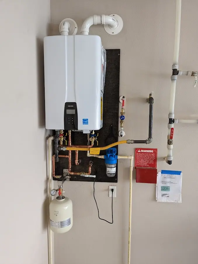 Professional plumber installing copper piping in a Centre home